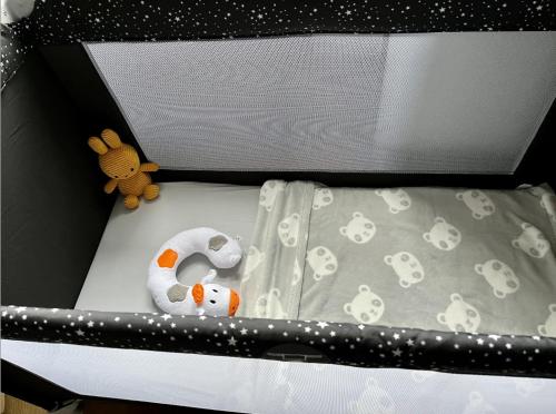 a baby crib with a stuffed animal on it at Le Chaumontais Écolo et sa terrasse privée in Chaumont