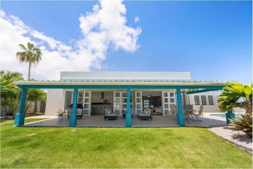 a house with a patio and a yard at Waterfront Luxury Home with Dock in San Juan in Pinones