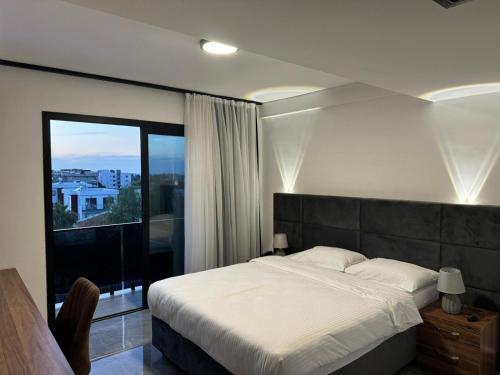 a bedroom with a large bed and a large window at Suya Boutique in Kyrenia