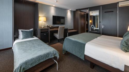 Ένα ή περισσότερα κρεβάτια σε δωμάτιο στο Van der Valk Hotel 's-Hertogenbosch – Vught