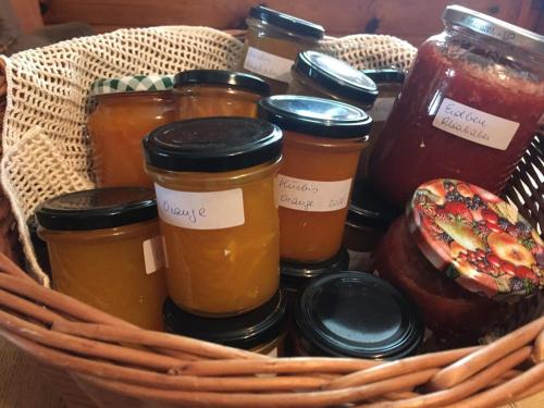 a basket filled with jars of honey and a donut at Pension Schindlau in Scharnstein