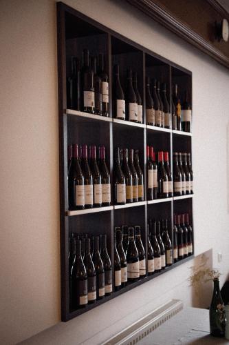 a bunch of bottles of wine on a wall at Anett hotel in Vipiteno