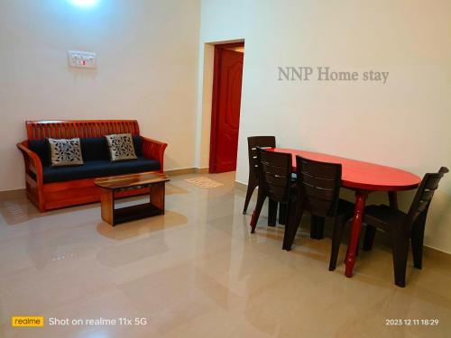 a living room with a table and chairs and a couch at NNP Home Stay Rameswaram in Rāmeswaram