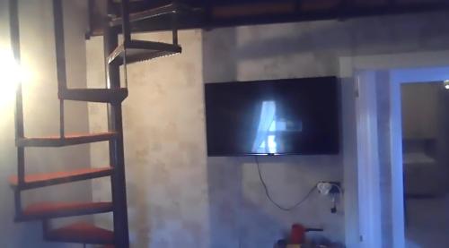 a television on a wall in a room with a ladder at grand friends in Antalya