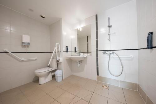 a bathroom with a toilet and a sink and a shower at Azureva Ronce les Bains in Ronce-les-Bains