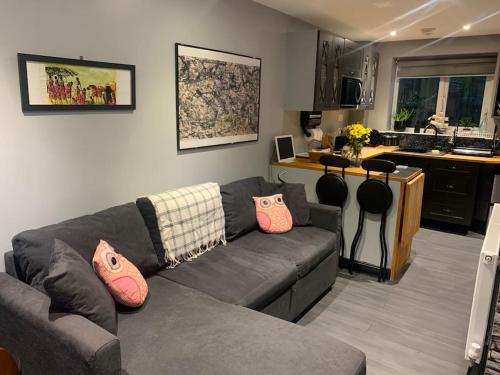 a living room with a couch and a kitchen at Kinterbury Annexe in Plymouth