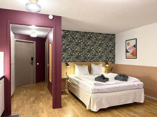 a bedroom with a large white bed in a room at 2Home Hotel Apartments in Solna