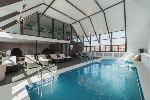 a pool in a building with a glass ceiling at Courtyard by Marriott Puerto Montt in Puerto Montt