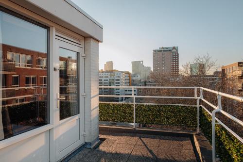 a balcony with a view of a city at Leonardo Hotel Rotterdam Savoy in Rotterdam