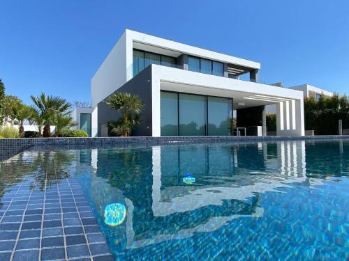 a house with a swimming pool in front of a house at Villa Algarve Paradise in Vilamoura