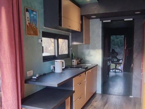 a kitchen with a sink and a counter top at Tiny House Montenegro in Petrovac na Moru