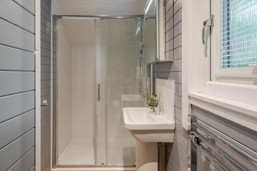 a bathroom with a shower and a sink at Long Ashes - Tan in Tattenhall