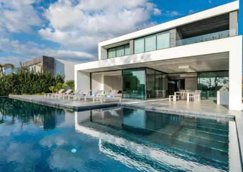 a house with a swimming pool in front of it at Villa Algarve Paradise in Vilamoura