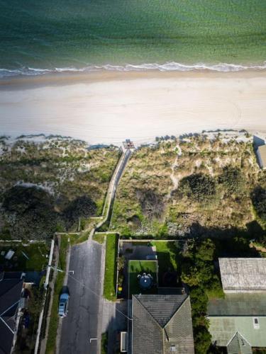an aerial view of a beach and the ocean at ChelseaVue - Designer Beachside Townhouse Retreat in Chelsea