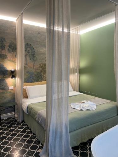 a bedroom with a bed with a curtain in it at Villa Marengo Guest House in Spinetta Marengo