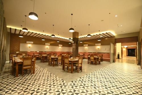 a dining room with wooden tables and chairs at Hotel Shyamleela in Khātu