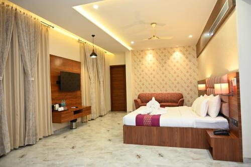 a hotel room with a bed and a television at Hotel Shyamleela in Khātu