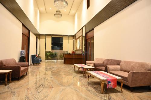 a lobby with couches and tables in a building at Hotel Shyamleela in Khātu