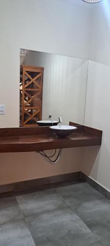 a bathroom with a counter with two sinks on it at Pousada Império in Serra do Cipo
