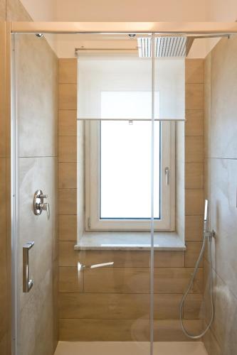 a bathroom with a shower and a window at DON PEPPE ROOMS : Villaggio Green in SantʼAngelo in Formis