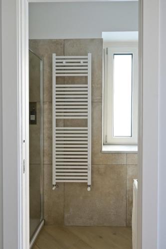 a bathroom with a shower with a window at DON PEPPE ROOMS : Villaggio Green in SantʼAngelo in Formis