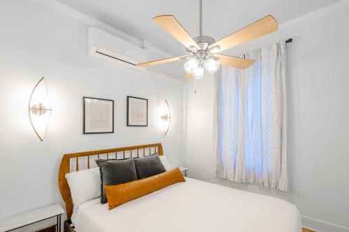 a bedroom with a bed and a ceiling fan at Old Spanish House- B, The Carter Jack Suite in Biloxi