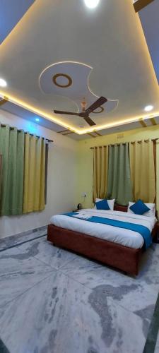 a bedroom with two beds and a ceiling at The Kashi Inn - Near Assighat in Upal