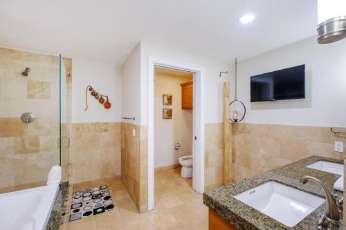 a bathroom with a sink and a shower and a toilet at Ocean Club 406 in Biloxi