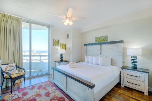 a bedroom with a large bed and a balcony at Ocean Club 406 in Biloxi