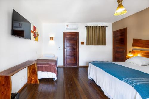 Кровать или кровати в номере Vila Coqueiros Boutique Hotel