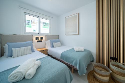 a bedroom with two beds with towels on them at Casa Boga in Puerto del Carmen
