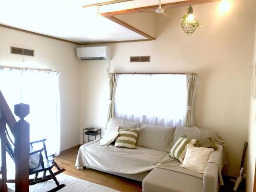 um sofá branco numa sala de estar com duas janelas em Villa Metasequoia - Vacation STAY 71245v em Takashima