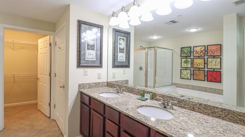 a bathroom with two sinks and a large mirror at Legacy II 603 Deluxe in Gulfport