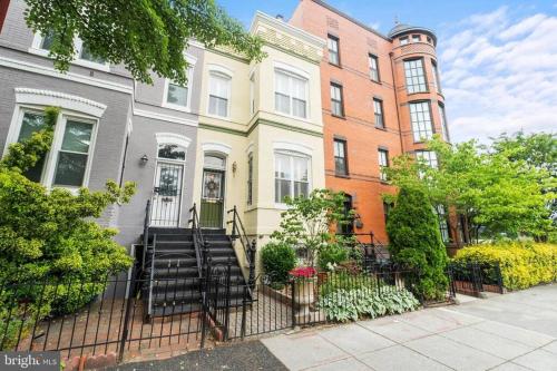 a row of houses in a city with a fence at Stay in the heart of Logan Circle: Fully Walkable in Washington