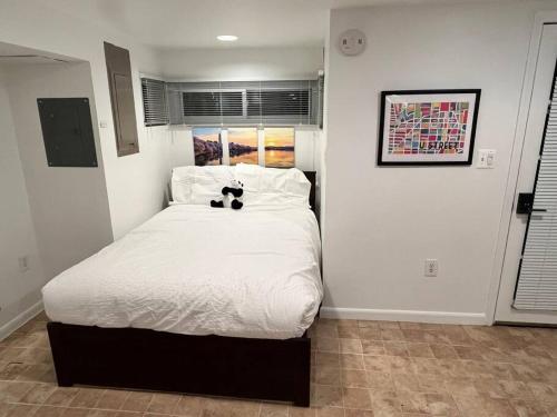a bedroom with a bed with a teddy bear on it at Stay in the heart of Logan Circle: Fully Walkable in Washington, D.C.