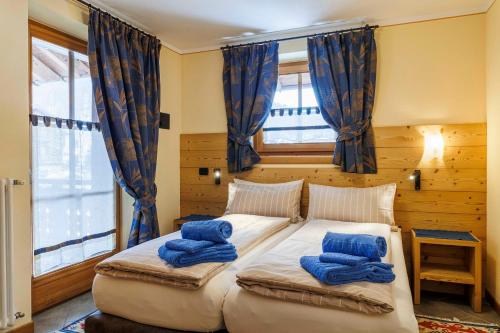 a bedroom with a large bed with blue pillows on it at Chalets Molin in Livigno