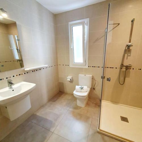 a bathroom with a toilet and a sink and a shower at Na Fonda Cala D'or in Cala d´Or