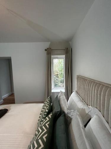 a bedroom with a large bed and a window at Mary’s Place in Cratloe