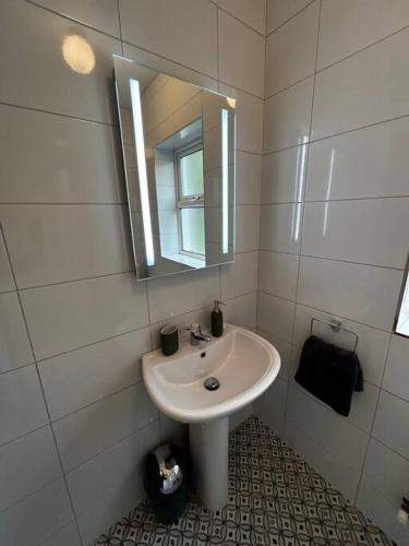 a bathroom with a sink and a mirror at Mary’s Place in Cratloe