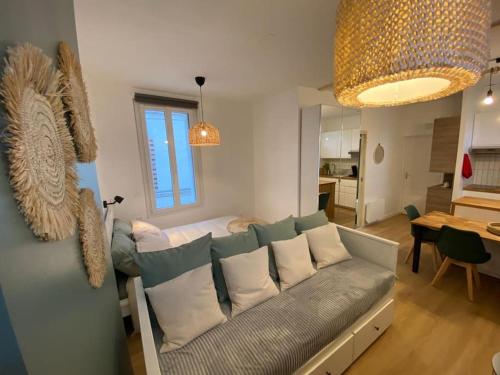 a living room with a couch and a table at Nid douillet tout équipé in Château-Renault