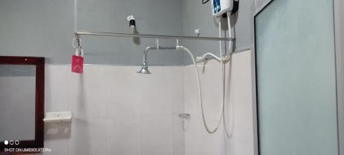 a shower with a shower head in a bathroom at Jungle Edge Home Sigiriya in Sigiriya