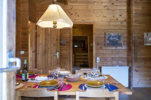a wooden table with plates and glasses on it at Chasa Avant Porta in Ramosch