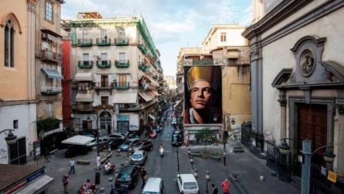 a city street with a large poster of a woman at Holiday House Duomo 202 in Naples