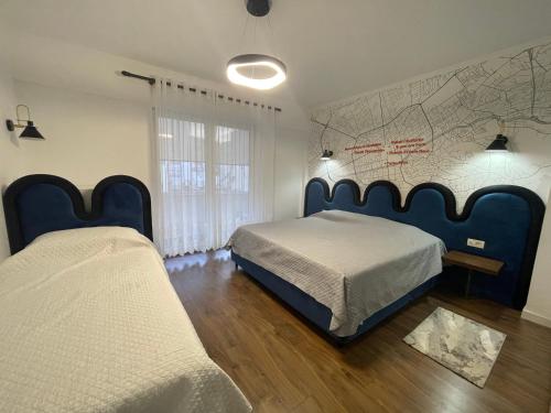a bedroom with two beds and a map on the wall at Tirana Center Apartment - Your Cosy Corner in Tirana