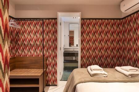 a bedroom with a bed with towels on it at BHomy Consolacao - Estiloso de 2 quartos MR132 in Sao Paulo