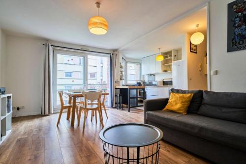 un salon avec un canapé et une table dans l'établissement Apartment balconyparking space near train station, à Lille