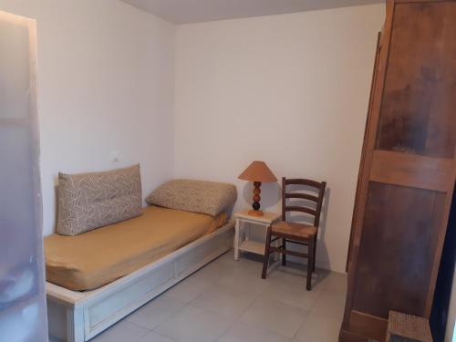 a small room with a bed and a chair at Kattalin enia in Anglet