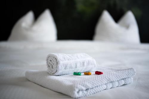 two towels with pills on them on a bed at Wifi Netflix free parking Gruben Apartment in Schaffhausen