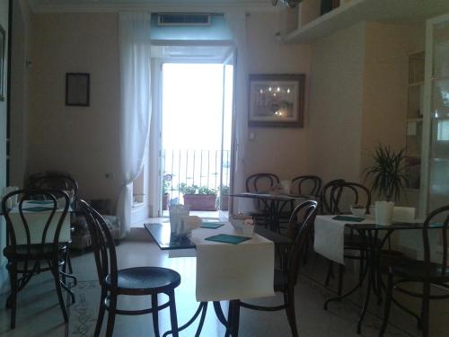 a dining room with tables and chairs and a window at La Dolce Vista - B&B di Charme in Manfredonia