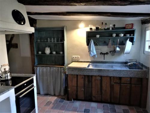 a kitchen with a sink and a counter top at Romantische Zeitreise in historischer Käserei in Unlingen